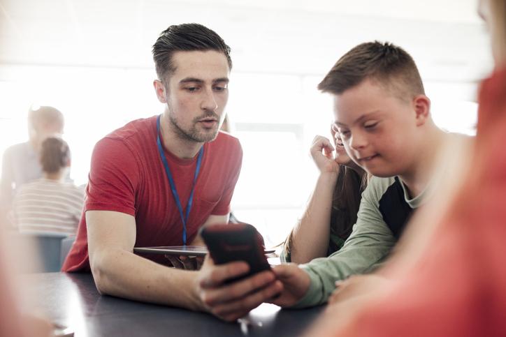 Two people looking at a mobile phone