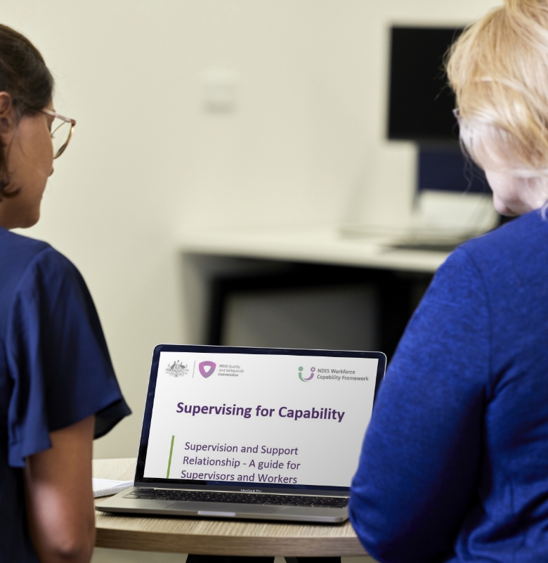 Women gathered around a laptop screen, gazing intently at this website.